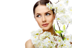 Beautiful Face of Young Woman with Clean Fresh Skin close up isolated on white. Beauty Portrait. Beautiful Spa Woman Smiling. Perfect Fresh Skin. Pure Beauty Model. Youth and Skin Care Concept