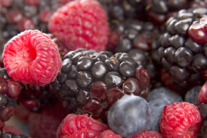 fresh berries in a bowl including raspberries blackberries and blueberries